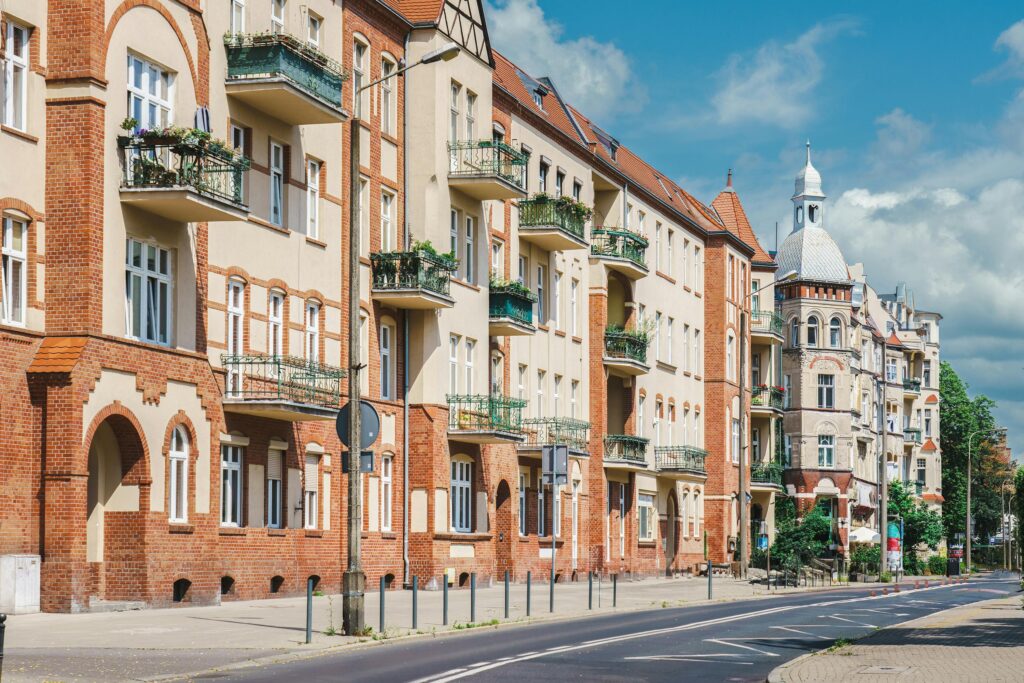 pexels-photo-17662844-17662844 Explore the classic architecture on a sunny street in Poznań, Poland, showcasing rich history.