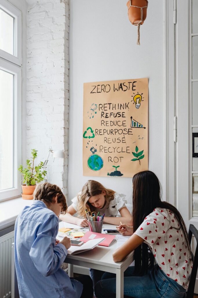 pexels-photo-7692675-7692675 Three teenagers working on a zero waste project together at a table, promoting sustainability and environmental awareness.
