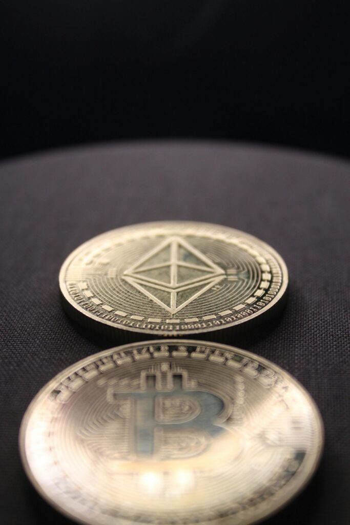 Detailed shot of Bitcoin and Ethereum coins on a dark surface.