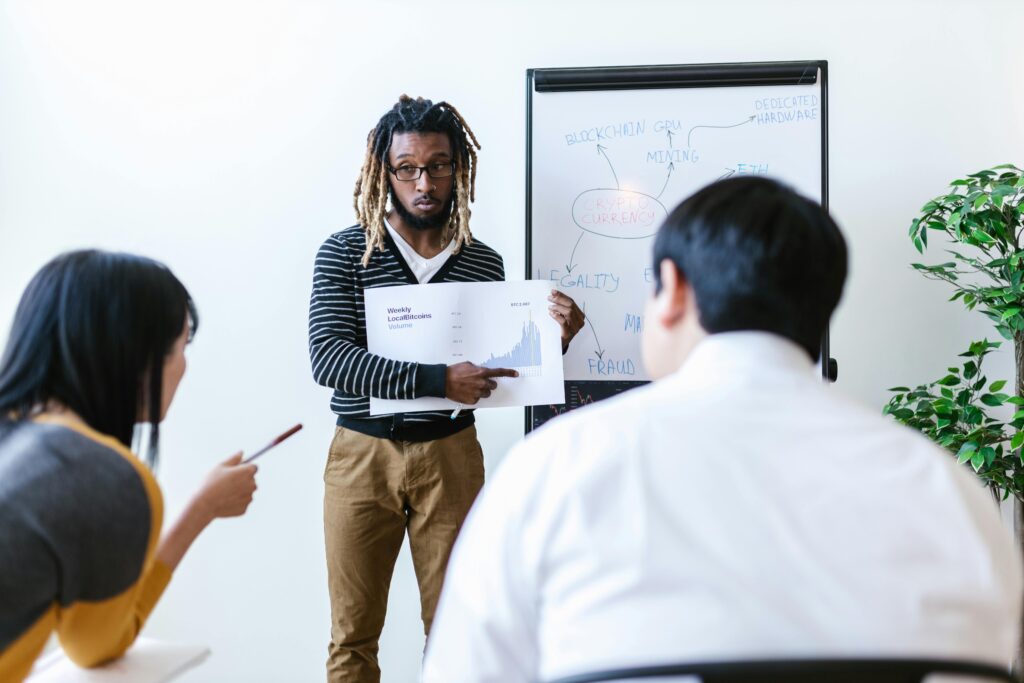 pexels-photo-8369779-8369779-2 Business team discussing cryptocurrency and blockchain strategies in an office setting with a focus on financial growth.